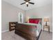 Comfortable bedroom with wood furniture, ceiling fan, and carpet flooring providing a cozy and inviting space at 4583 Emprise Way, Land O Lakes, FL 34638