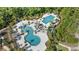 Stunning aerial view of resort-style pools surrounded by palm trees, offering a luxurious recreation experience at 4583 Emprise Way, Land O Lakes, FL 34638