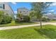 Charming two-story home with a well-manicured lawn, tropical landscaping, and a spacious two-car garage at 4583 Emprise Way, Land O Lakes, FL 34638
