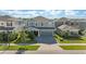 Charming two-story home features a well-manicured lawn, driveway, and a covered front porch at 4583 Emprise Way, Land O Lakes, FL 34638