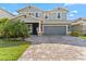Charming two-story home with a paved driveway, a two-car garage, and landscaping at 4583 Emprise Way, Land O Lakes, FL 34638