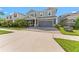 Beautiful two-story home with a welcoming front porch, stone accents, and a paved driveway leading to the garage at 4583 Emprise Way, Land O Lakes, FL 34638