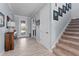 Entryway with a staircase, wood floors, and a view of the front door and hallway at 4583 Emprise Way, Land O Lakes, FL 34638