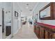 Light and airy hallway with wood floors, a mirror, and views into living spaces at 4583 Emprise Way, Land O Lakes, FL 34638