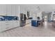 Bright kitchen with white cabinets, stainless steel appliances, and a central island with barstool seating at 4583 Emprise Way, Land O Lakes, FL 34638