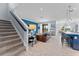 Open floor plan with stairs, a living room with a sofa, and a kitchen with a breakfast bar at 4583 Emprise Way, Land O Lakes, FL 34638