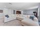 Spacious living room area featuring a large comfortable sofa, and ample space for entertainment and relaxation at 4583 Emprise Way, Land O Lakes, FL 34638