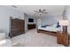 Spacious main bedroom with a ceiling fan, TV, and a dresser at 4583 Emprise Way, Land O Lakes, FL 34638