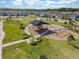 Aerial view of community playground with modern equipment, surrounded by lush landscaping, perfect for outdoor fun at 4583 Emprise Way, Land O Lakes, FL 34638