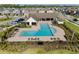 Aerial view of a community pool with ample seating, ideal for relaxation and recreation at 4583 Emprise Way, Land O Lakes, FL 34638