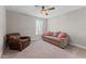 Cozy sitting room featuring comfortable seating, a ceiling fan, and natural light creating a relaxing space at 4583 Emprise Way, Land O Lakes, FL 34638