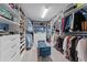 Spacious walk-in closet featuring custom shelving, drawers, hanging racks, and a comfortable bench for added convenience at 4583 Emprise Way, Land O Lakes, FL 34638