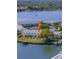 Aerial view showcasing waterfront condos with boat docks and serene water views at 5242 Beach Se Dr, St Petersburg, FL 33705