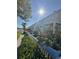Exterior of charming townhomes featuring balconies, lush landscaping, and serene waterfront views at 5242 Beach Se Dr, St Petersburg, FL 33705