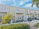 Townhome exterior with a white fence, patio, and balcony, creating a charming and inviting outdoor space at 5242 Beach Se Dr, St Petersburg, FL 33705