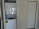 This laundry area has a stacked washer and dryer hidden behind a closet at 5242 Beach Se Dr, St Petersburg, FL 33705