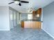 Spacious living area with neutral walls, tile floors, a ceiling fan, and an open flow to the kitchen at 5242 Beach Se Dr, St Petersburg, FL 33705