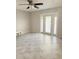 This airy living room has tile floors and French doors leading to a balcony at 5242 Beach Se Dr, St Petersburg, FL 33705