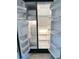 Spacious side-by-side refrigerator with ample shelving and storage options for optimal organization at 5242 Beach Se Dr, St Petersburg, FL 33705