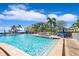 A sparkling swimming pool with palm trees, lounge chairs, and a relaxing atmosphere at 5242 Beach Se Dr, St Petersburg, FL 33705