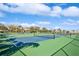 Tennis courts on a sunny day with blue sky and buildings in the background at 5242 Beach Se Dr, St Petersburg, FL 33705