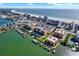Aerial view capturing waterfront condo buildings, boat docks, and nearby beach amenities at 5301 Gulf Blvd # B508, St Pete Beach, FL 33706