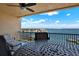 Spacious balcony with comfortable seating and stunning views of the water and city skyline at 5301 Gulf Blvd # B508, St Pete Beach, FL 33706