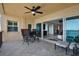 Balcony with seating area leads to a cozy living room with sliding glass doors showcasing waterfront views at 5301 Gulf Blvd # B508, St Pete Beach, FL 33706
