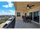 Balcony with patio furniture offers views of a pool, marina, and city skyline in the distance at 5301 Gulf Blvd # B508, St Pete Beach, FL 33706
