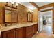Bathroom with a double vanity, stylish mirrors, and a doorway to another room at 5301 Gulf Blvd # B508, St Pete Beach, FL 33706
