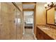 Tiled bathroom has a tiled shower, vanity, and a view into the bedroom at 5301 Gulf Blvd # B508, St Pete Beach, FL 33706