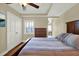 This bedroom has wood floors, a ceiling fan, and an outdoor view at 5301 Gulf Blvd # B508, St Pete Beach, FL 33706
