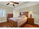 This furnished bedroom has a ceiling fan and wood flooring at 5301 Gulf Blvd # B508, St Pete Beach, FL 33706