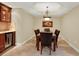 Dining room with elegant table, chandelier, and a built-in wine fridge at 5301 Gulf Blvd # B508, St Pete Beach, FL 33706
