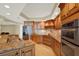 Modern kitchen with stainless steel appliances, stone countertops, bar stool seating and custom wood cabinets at 5301 Gulf Blvd # B508, St Pete Beach, FL 33706
