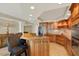 Gourmet kitchen with granite countertops, stainless appliances, and custom cabinets leading to an adjacent sitting area at 5301 Gulf Blvd # B508, St Pete Beach, FL 33706