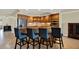 Spacious kitchen with custom wood cabinets, granite countertops, stainless appliances and bar stool seating at 5301 Gulf Blvd # B508, St Pete Beach, FL 33706
