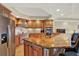 Well-equipped kitchen with granite countertops, stainless steel appliances, wooden cabinetry, and a large kitchen island at 5301 Gulf Blvd # B508, St Pete Beach, FL 33706