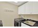 Laundry room featuring a washer and dryer, with ample counter space and cabinet storage at 5301 Gulf Blvd # B508, St Pete Beach, FL 33706