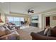 Inviting living room featuring comfortable seating, a ceiling fan, and large windows with views to the outside at 5301 Gulf Blvd # B508, St Pete Beach, FL 33706