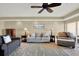 Cozy living room with neutral paint, a patterned rug, and comfortable seating under a ceiling fan at 5301 Gulf Blvd # B508, St Pete Beach, FL 33706