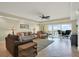 Comfortable living room with ceiling fan, plush seating, tile floors and sliding glass doors to an outdoor space at 5301 Gulf Blvd # B508, St Pete Beach, FL 33706