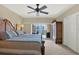 Main bedroom with a ceiling fan, closet, and access to a private balcony at 5301 Gulf Blvd # B508, St Pete Beach, FL 33706