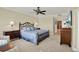 Comfortable bedroom showcasing a stylish bed frame, lamps, and neutral carpet at 5301 Gulf Blvd # B508, St Pete Beach, FL 33706