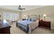 Well-lit main bedroom features a decorative bed frame, two side tables, and plantation shutters for privacy at 5301 Gulf Blvd # B508, St Pete Beach, FL 33706