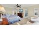 Spacious main bedroom featuring a ceiling fan, television, and comfortable seating at 5301 Gulf Blvd # B508, St Pete Beach, FL 33706