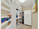Pantry with shelving, fridge and water heater for convenient storage at 5301 Gulf Blvd # B508, St Pete Beach, FL 33706