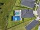 Aerial view of a large property with basketball court, pool, and manicured landscaping and lawn at 5409 Del Coronado Dr, Apollo Beach, FL 33572