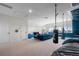 Bright bonus room offers space for exercise and entertainment, and features neutral walls and carpet at 5409 Del Coronado Dr, Apollo Beach, FL 33572