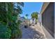 Paver patio in a private backyard offering seating and a storage shed, surrounded by lush tropical plants at 5785 Bay Pines Lakes Blvd, St Petersburg, FL 33708